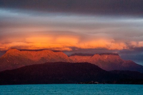 Sunset across Kachemak Bay from hotel on Homer Spit, Alaska