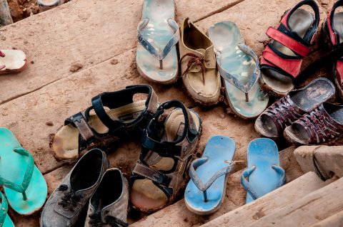 Shoes at entrance, Akha village, Laos