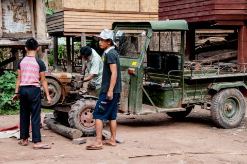 Repairing the tractor,  Akha village, Laos