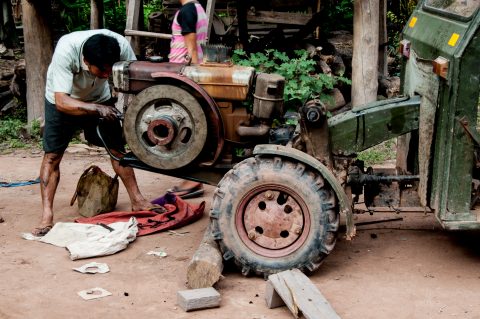 Repairing the tractor,  Akha village, Laos