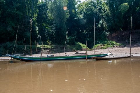 Boats moored on banks of Nam Ou River, Laos