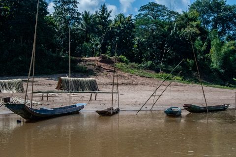 Boats moored on banks of Nam Ou River, Laos