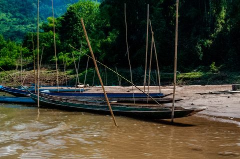 Boats moored on banks of Nam Ou River, Laos