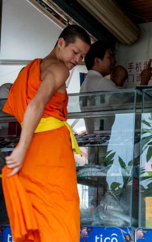 Monk in market, Luang Prabang, Laos
