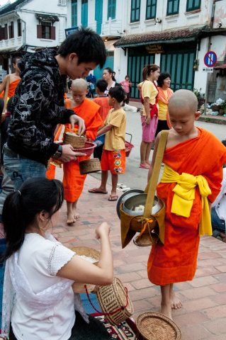 Giving  & receiving breakfast alms, Luang Prabang, Laos