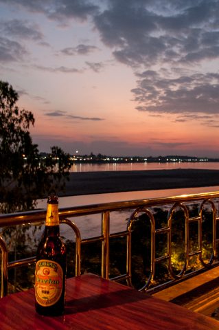 Local beer at sunset over Mekong, Vientiane, Laos